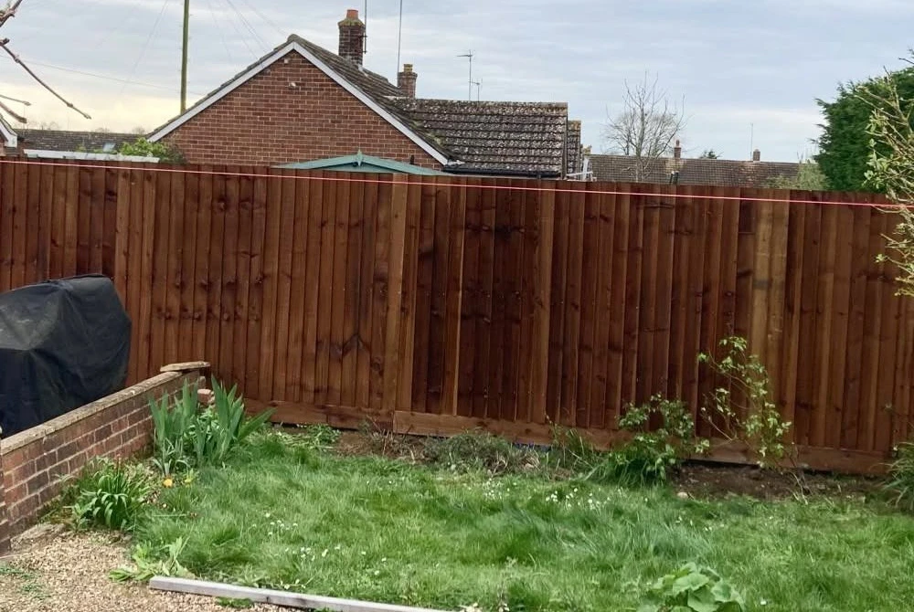 Timber fence beside a garden lawn by Boothville Services.