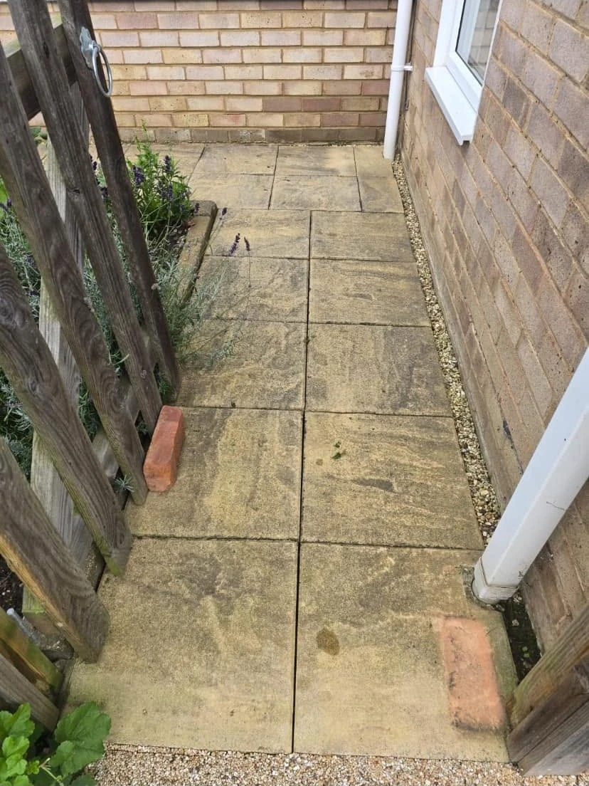 Dirty paved side passage before cleaning by Boothville Services.