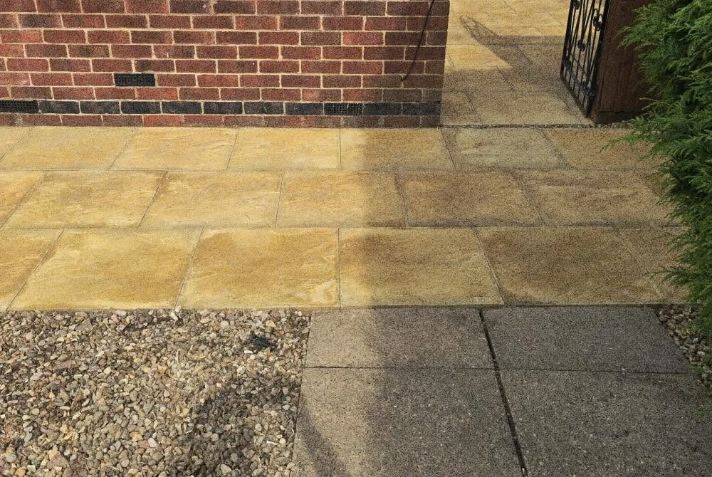 New pale paving leading to a garden gate by Boothville Services.