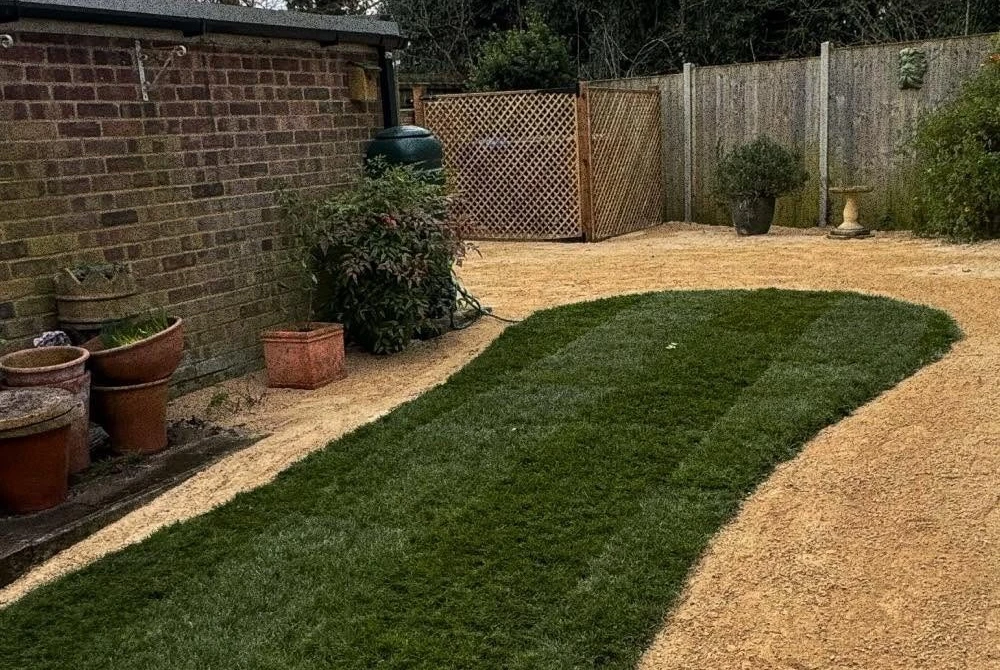Finished lawn bordered by gravel by Boothville Services.