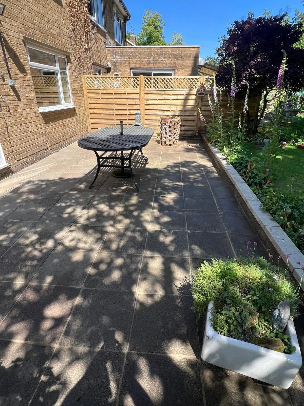 Cleaned paved patio beside garden seating by Boothville Services.