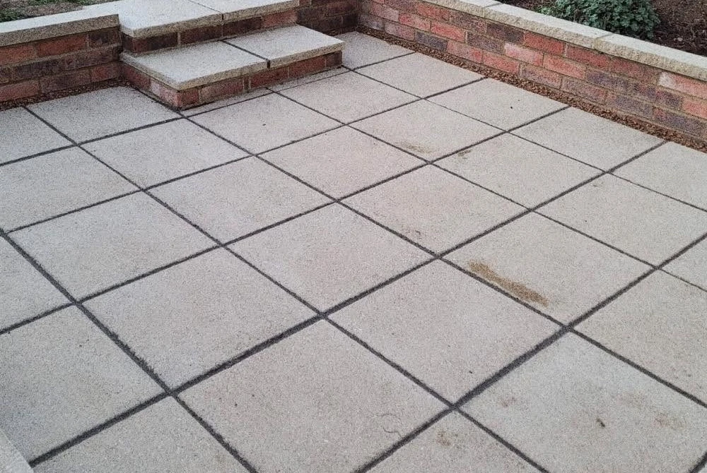 New slab patio with steps and retaining walls by Boothville Services.